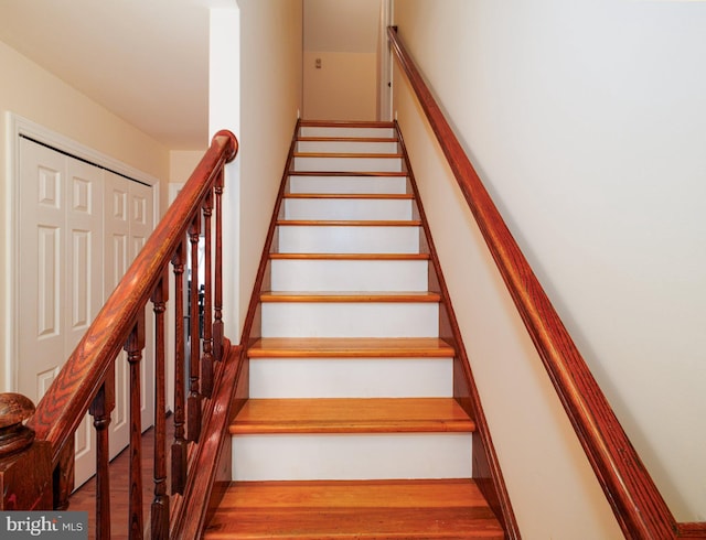 stairs featuring wood finished floors