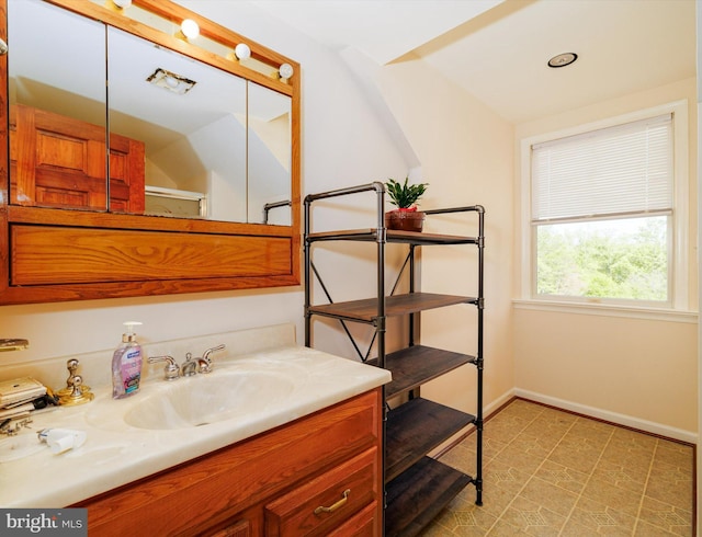 bathroom with baseboards and vanity