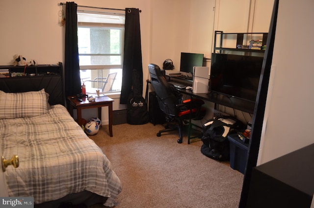 carpeted bedroom featuring an office area