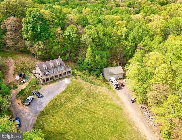 view from above of property featuring a heavily wooded area