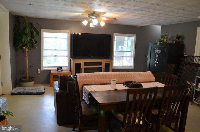 dining area featuring healthy amount of natural light, a ceiling fan, and finished concrete flooring
