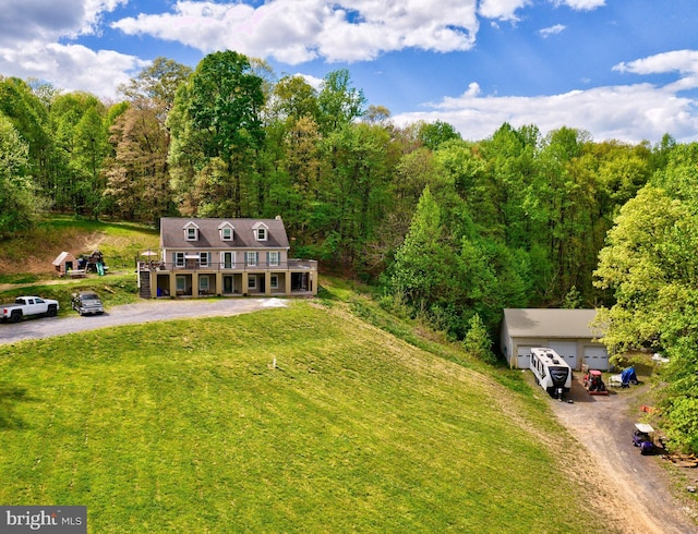 aerial view of property and surrounding area with a heavily wooded area