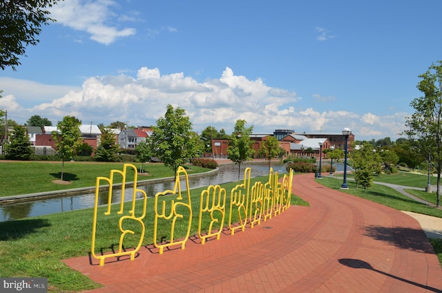 view of community featuring a yard and a water view