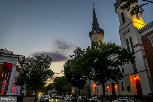 view of asphalt road with street lighting and sidewalks