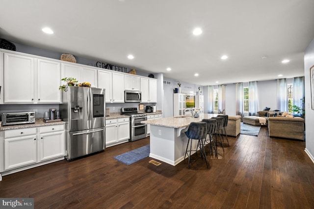 131 Time Cir, Bear, DE 19701 - kitchen with stainless steel appliances, a sink, a toaster, open floor plan, and a breakfast bar