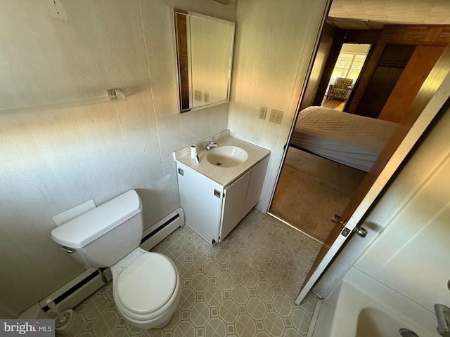 4747 Tyaskin Rd, Tyaskin, MD 21865 - bathroom featuring baseboard heating, vanity, wooden walls, and toilet