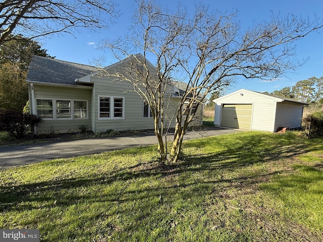 4747 Tyaskin Rd, Tyaskin, MD 21865 - exterior space with a detached garage, a lawn, aphalt driveway, an outbuilding, and roof with shingles