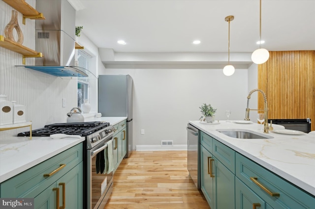 kitchen with green cabinetry, open shelves, a sink, and appliances with stainless steel finishes