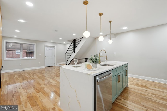 kitchen with stainless steel dishwasher, baseboards, a sink, and light wood-style floors
