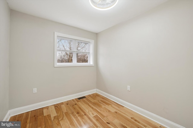 unfurnished room with baseboards, visible vents, and light wood finished floors