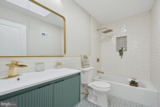 full bathroom featuring toilet, tile walls, visible vents, shower / bath combination, and vanity