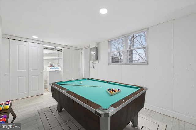 game room featuring washer / dryer, light wood-style flooring, electric panel, and pool table