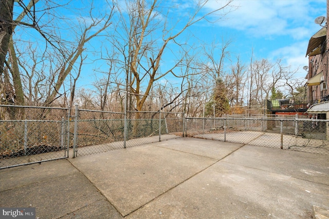 view of patio featuring fence and a gate