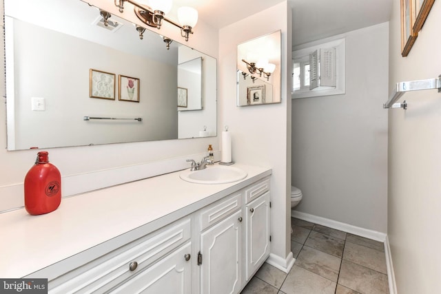 bathroom with vanity, baseboards, toilet, tile patterned flooring, and visible vents