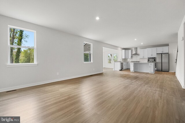 109 Hillsdale Dr, Fredericksburg, VA 22405 - unfurnished living room featuring healthy amount of natural light, light wood-style floors, and recessed lighting