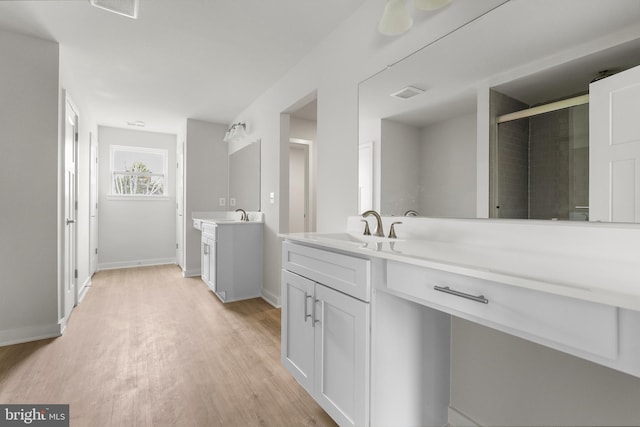 109 Hillsdale Dr, Fredericksburg, VA 22405 - bathroom with two vanities, wood finished floors, and a shower stall