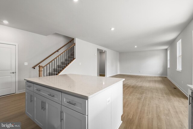 109 Hillsdale Dr, Fredericksburg, VA 22405 - kitchen with light wood-type flooring, a kitchen island, recessed lighting, light stone counters, and gray cabinets