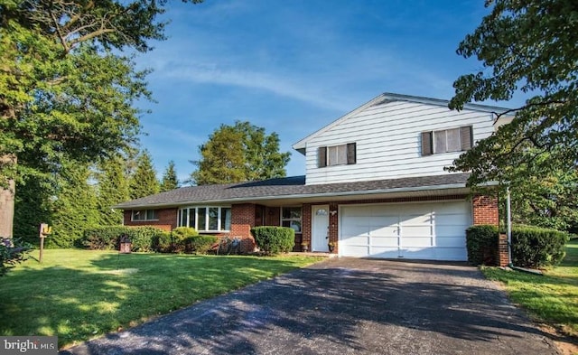 2300 Locust Rd, Dover, PA 17315 - view of front of property featuring asphalt driveway, brick siding, a front yard, and an attached garage