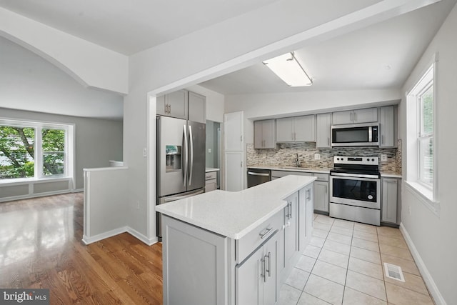 1258 Magnolia, Herndon, VA 20170 - kitchen with appliances with stainless steel finishes, gray cabinetry, light countertops, a sink, and vaulted ceiling