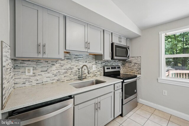 1258 Magnolia, Herndon, VA 20170 - kitchen featuring stainless steel appliances, a sink, decorative backsplash, light tile patterned flooring, and gray cabinetry