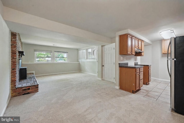 1258 Magnolia, Herndon, VA 20170 - kitchen featuring freestanding refrigerator, open floor plan, brown cabinets, under cabinet range hood, and light colored carpet