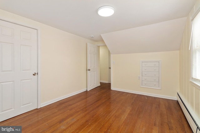 4 Cavan Dr, Lutherville Timonium, MD 21093 - additional living space featuring a baseboard heating unit, baseboards, a healthy amount of sunlight, and wood finished floors