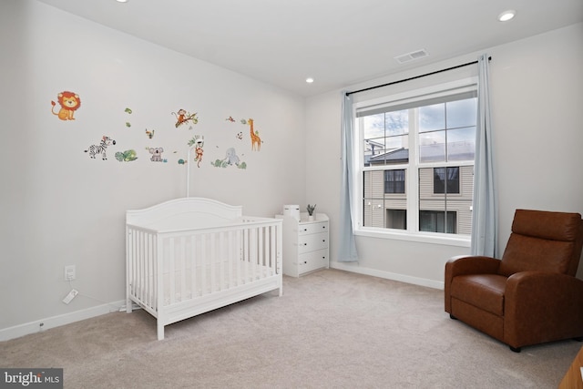 bedroom featuring a crib, visible vents, carpet, and recessed lighting