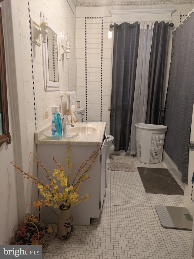 full bath with tile walls, toilet, and vanity
