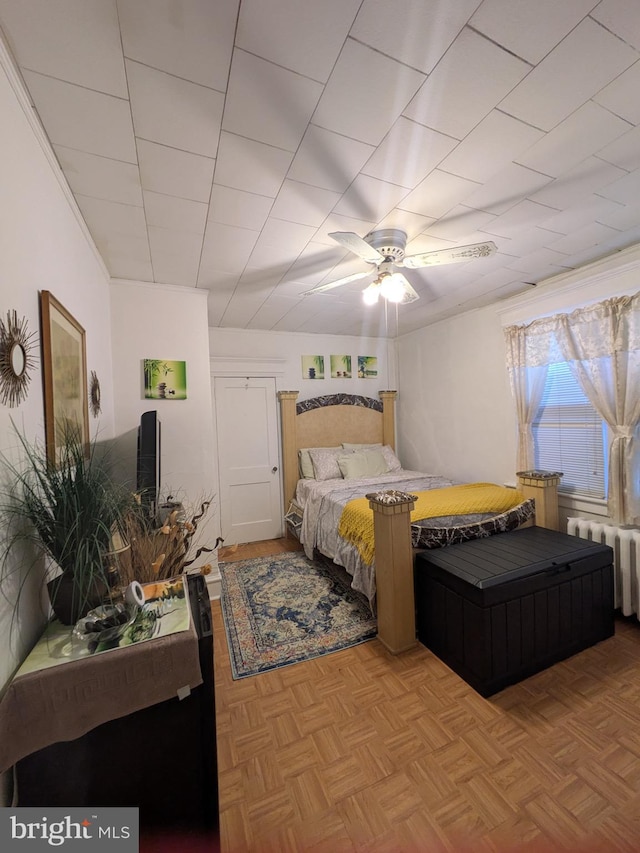 bedroom featuring radiator heating unit and a ceiling fan