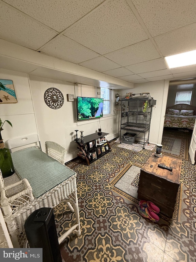 living room with a paneled ceiling