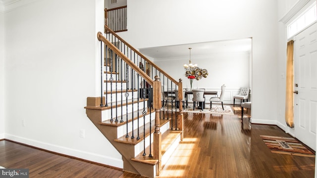 13002 Walkers Ln, Bowie, MD 20721 - foyer entrance featuring ornamental molding, dark wood-style flooring, stairs, baseboards, and a notable chandelier