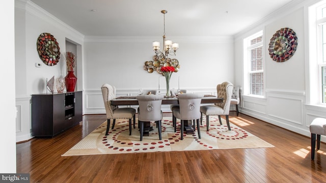 13002 Walkers Ln, Bowie, MD 20721 - dining room featuring an inviting chandelier, ornamental molding, a wealth of natural light, and wood finished floors