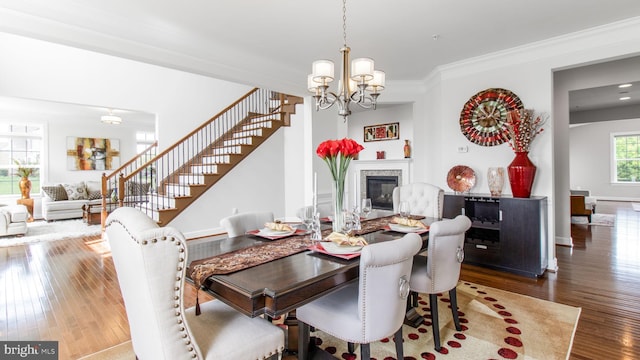 13002 Walkers Ln, Bowie, MD 20721 - dining area with a notable chandelier, hardwood / wood-style floors, stairs, a high end fireplace, and ornamental molding