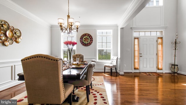 13002 Walkers Ln, Bowie, MD 20721 - dining space featuring crown molding, wood finished floors, a chandelier, and a wealth of natural light