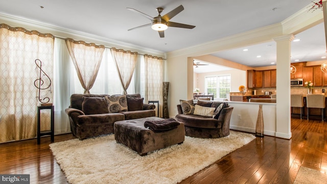 13002 Walkers Ln, Bowie, MD 20721 - living area featuring crown molding, ceiling fan, decorative columns, and dark wood-style floors