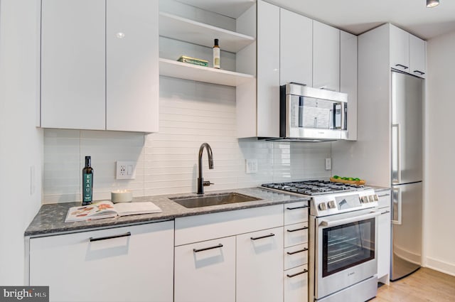 70 N Street Street SE Unit N916, Washington, DC 20003 - kitchen with tasteful backsplash, dark stone countertops, appliances with stainless steel finishes, and a sink