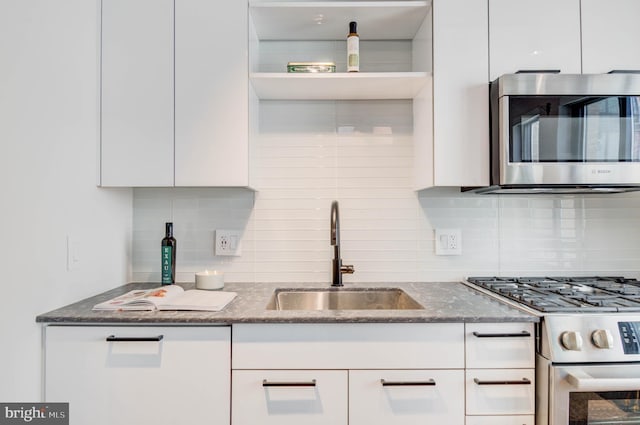 70 N Street Street SE Unit N916, Washington, DC 20003 - kitchen featuring decorative backsplash, white cabinetry, stainless steel appliances, and a sink