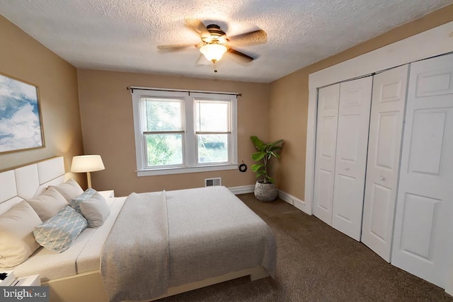 carpeted bedroom featuring a ceiling fan, visible vents, a textured ceiling, and a closet