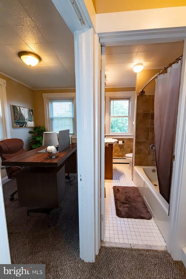 carpeted office space featuring a baseboard radiator and crown molding