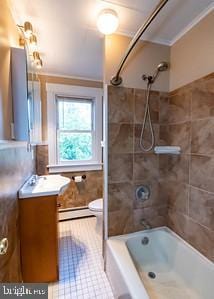 full bathroom with baseboard heating, vanity, tub / shower combination, toilet, and tile patterned flooring