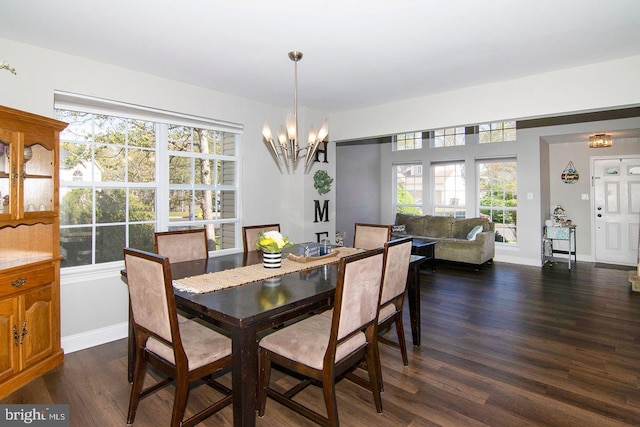 dining space with baseboards, an inviting chandelier, and dark wood-type flooring
