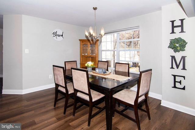 dining space with dark wood-style flooring, baseboards, and a chandelier