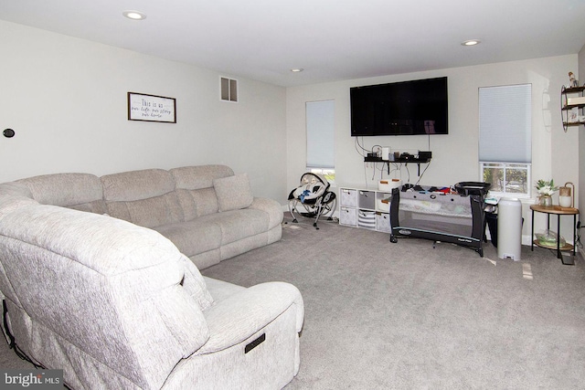 living room with visible vents, recessed lighting, and carpet