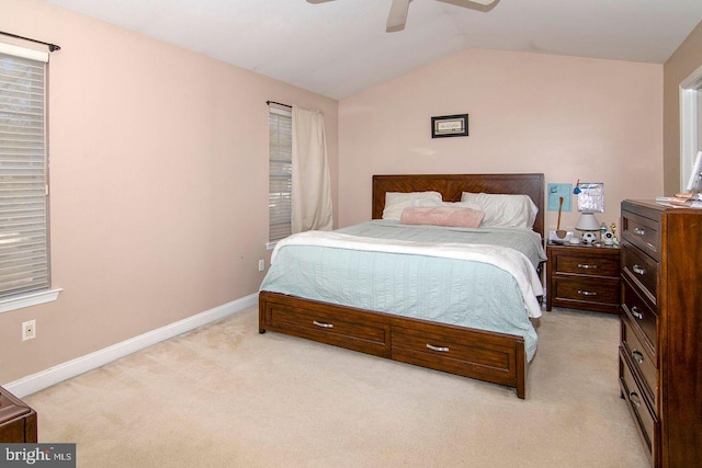 bedroom featuring baseboards, a ceiling fan, light colored carpet, and lofted ceiling