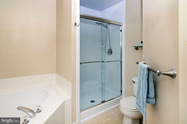 full bath featuring tile patterned floors, a shower stall, toilet, and a garden tub