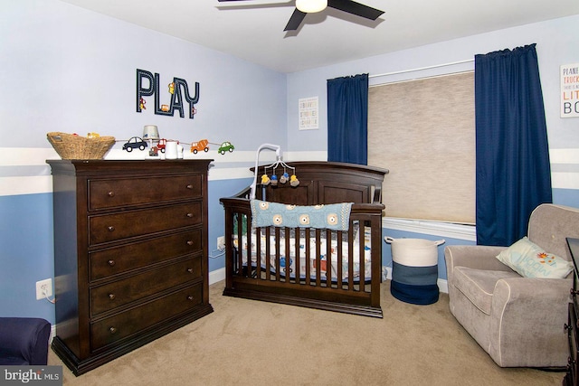 carpeted bedroom with baseboards and a ceiling fan