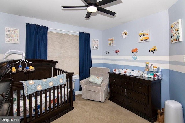 bedroom featuring carpet flooring, a crib, and ceiling fan