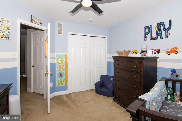 bedroom featuring ceiling fan, light colored carpet, baseboards, visible vents, and a closet