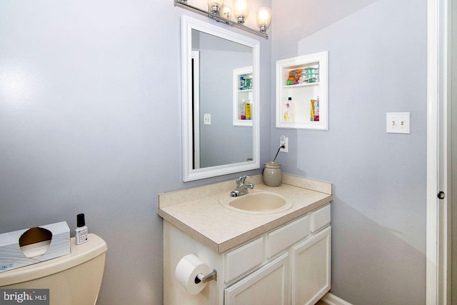 bathroom featuring toilet and vanity