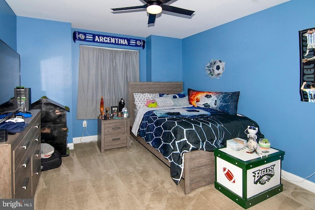 carpeted bedroom featuring baseboards and ceiling fan